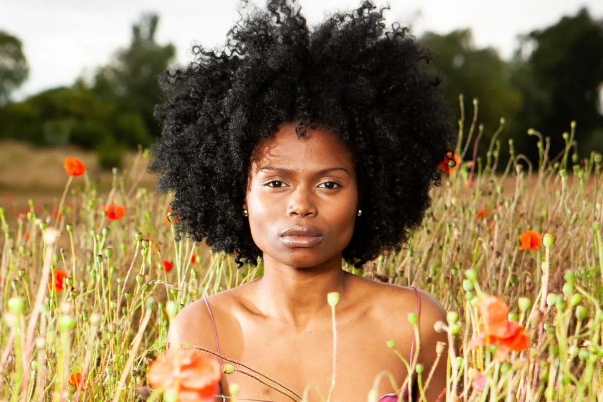 woman sitting in wildflowers